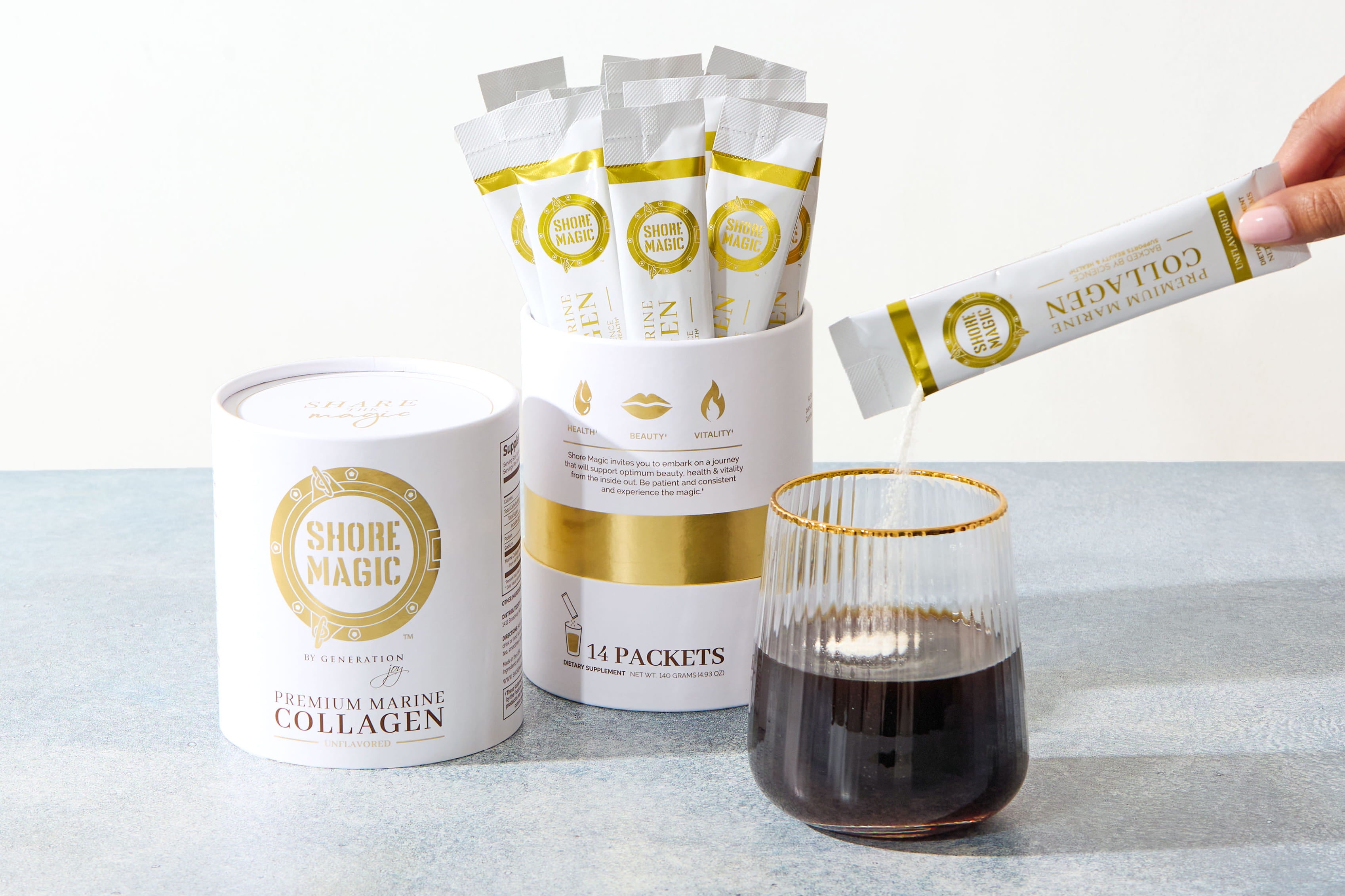Woman pouring packet of collagen powder into a glass cup of coffee